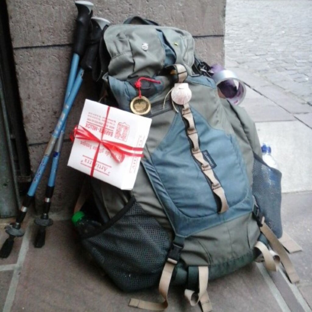 photo of backpack and trekking poles
