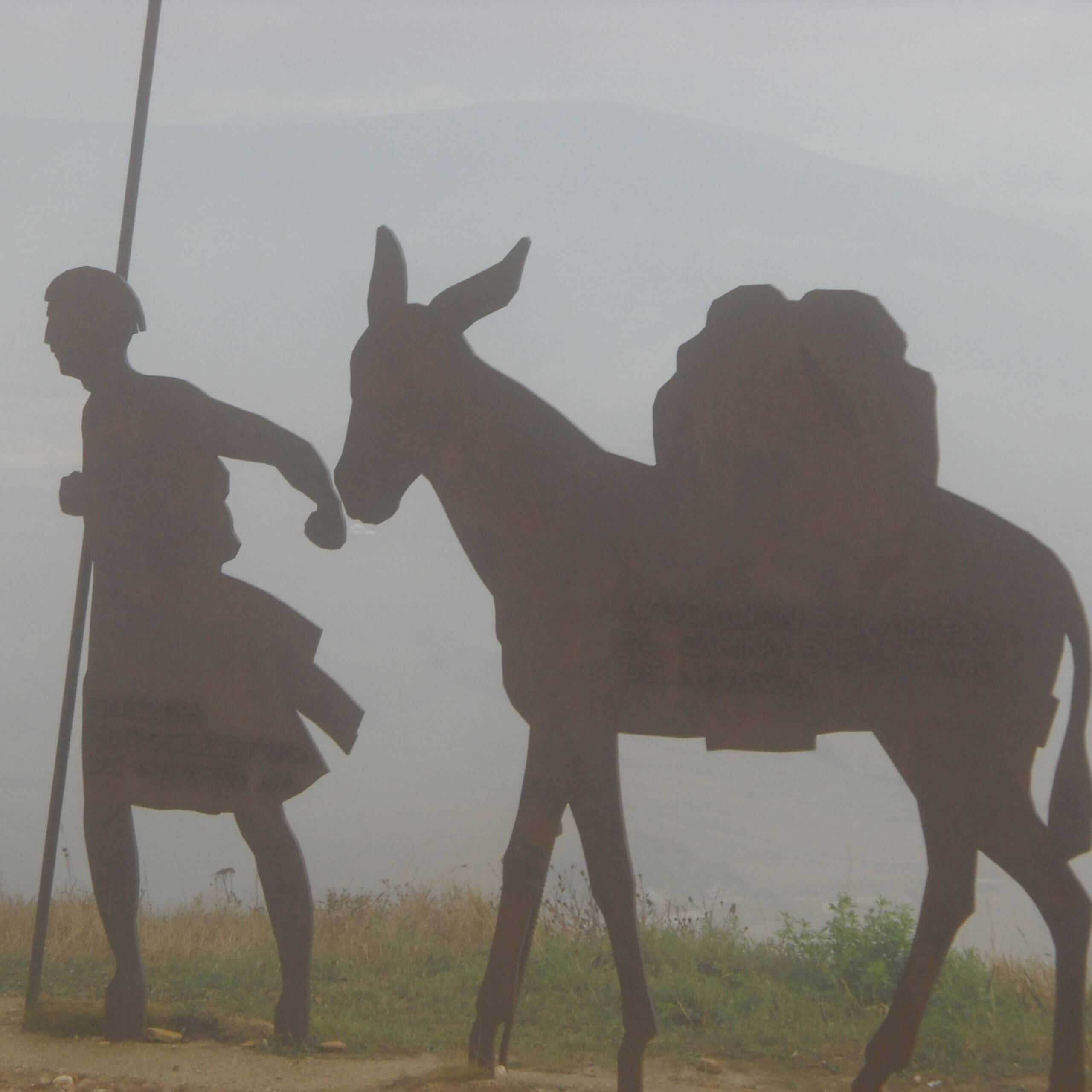 pilgrim leading donkey statue at alto del perdon