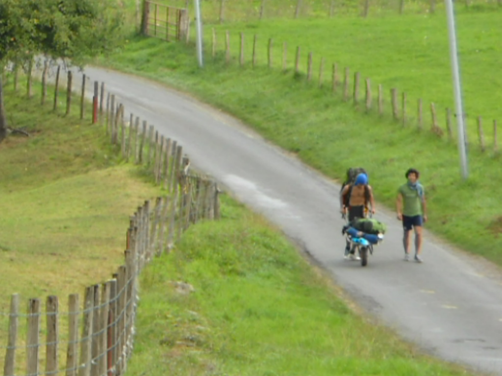 Two pilgrims walking uphill from Saint Jean Pied de Port to Honto on the Napoleon route of the Camino de Santiago