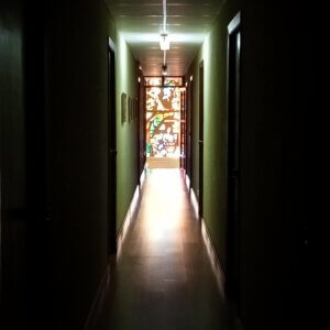 dark hallway with stained glass window