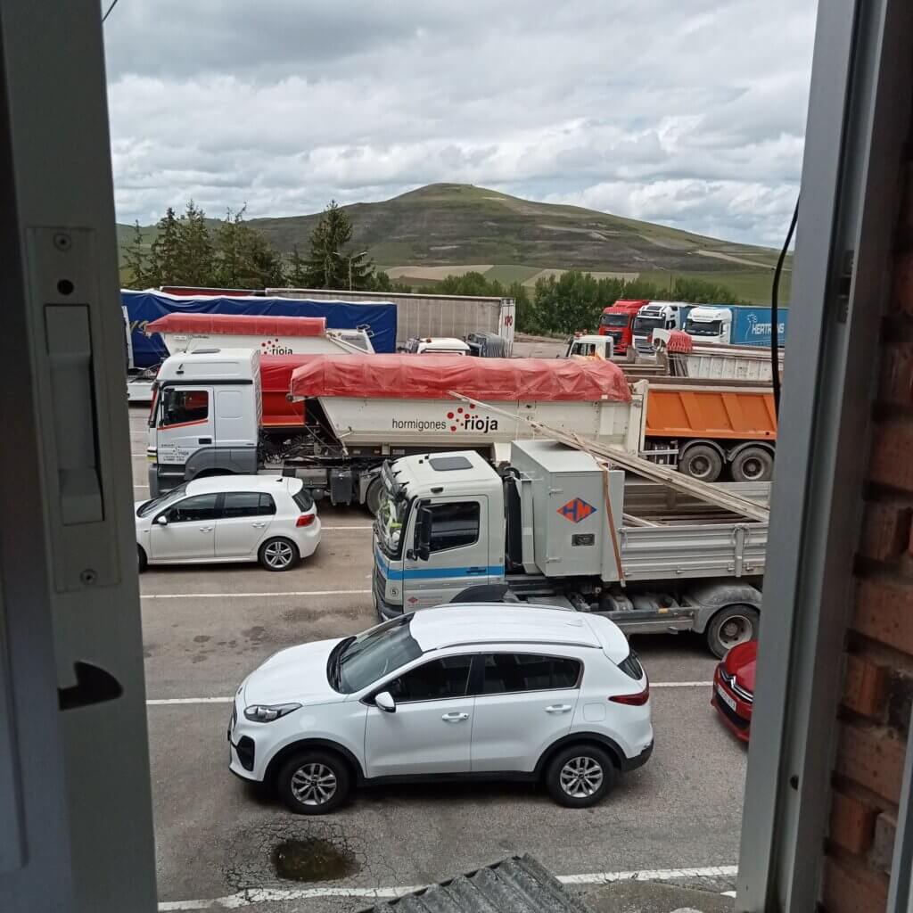 parking lot with trucks and cars