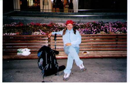 woman on bench with backpack